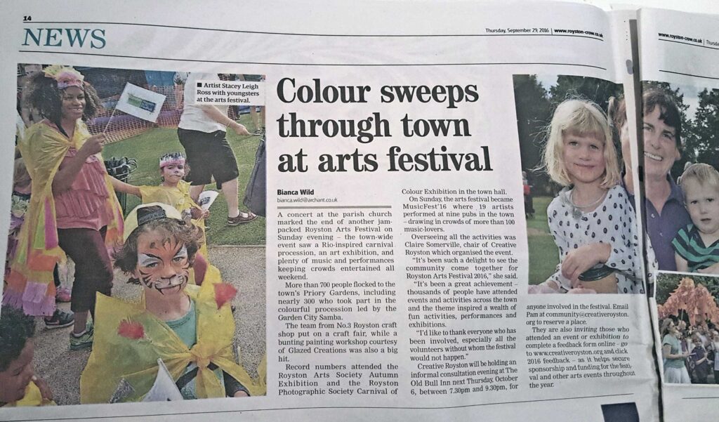 Royston Crow article about Royston Arts Festival Carnival-like parade showing image of by Leigh artist, Stacey Leigh Ross, surrounded by children who made capes as part of her Carnival craft workshops for Royston Museum. The costumed children were then part of the Carnival - like parade hosted for the Royston Arts Festival 2016yston Museum