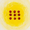 9 red dots with little squiggles scratched into them revealing the yellow textured background behind them