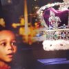 Cropped photo of a billboard at St Pancras in 2019 showing a black boy gazing longingly at the crown jewels