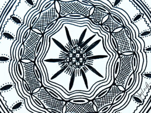 Cropped intricate circular pattern almost like a henna tattoo or mandala but of African design influence.