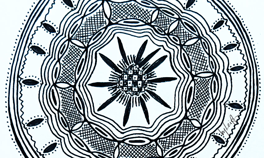 Cropped intricate circular pattern almost like a henna tattoo or mandala but of African design influence.