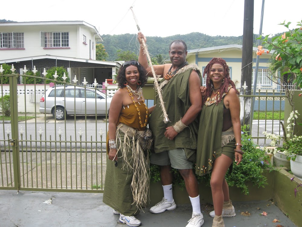 3 masqueraders in similar colours and fabrics but all in different fashions and styles.