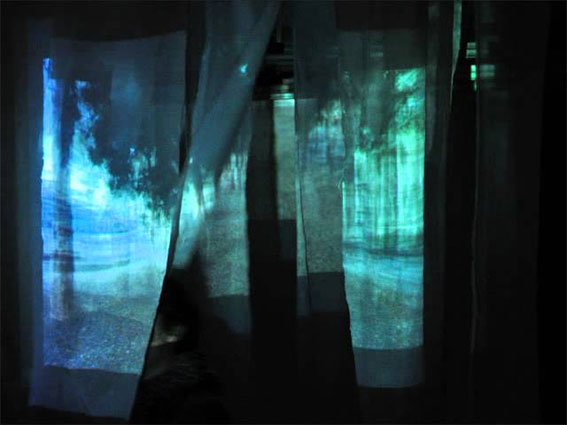 showing projections on broad strips of fabric hanging from the ceiling at intervals