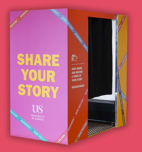 Multicoloured video booth labelled "Share Your Story" by Green Screen UK