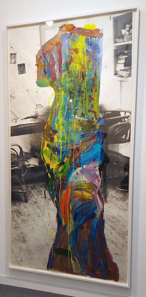 black and white print of a room with colourful female form superimposed on print. the form is a messy merger of colours and is missing one arm while in the pose of many old sculptures