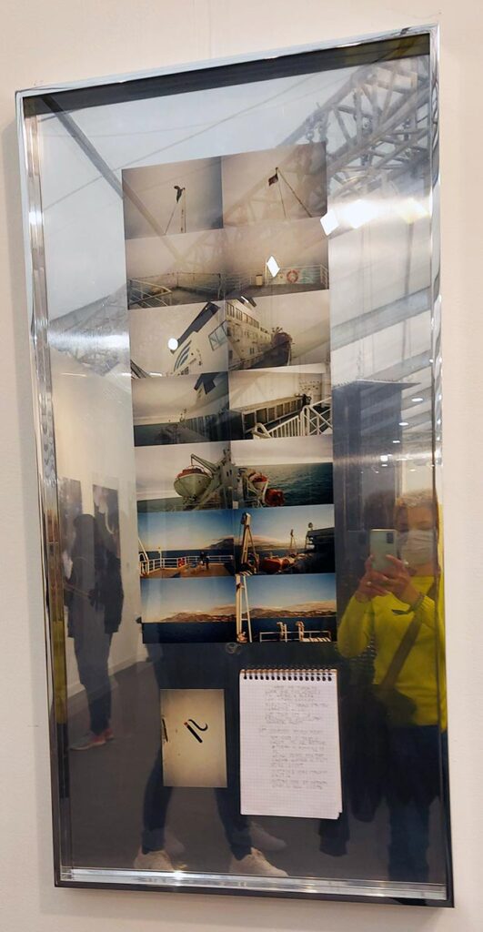 a collection of photos mounted in 2 columns with a small lines sprial bound notebook. All set within a silver mirror effect frame