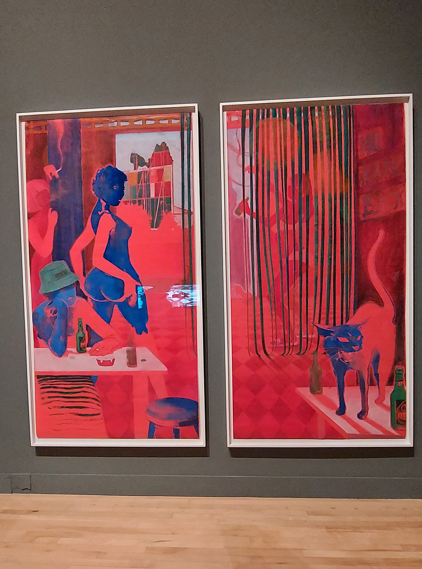 2 paintings with mainly red overtones. 1 painting shows a voluptuous blue nude walking away but turning back, while another woman sits at a table drinking with a hat on, and a third woman leans on a pillar with cigarette in hand. The 2nd painting shows a strip curtain with a woman dancing behind it with a beer bottle in hand. In the foreground a blue cat screeches from the top of a bar table with 2 beer bottles on it.