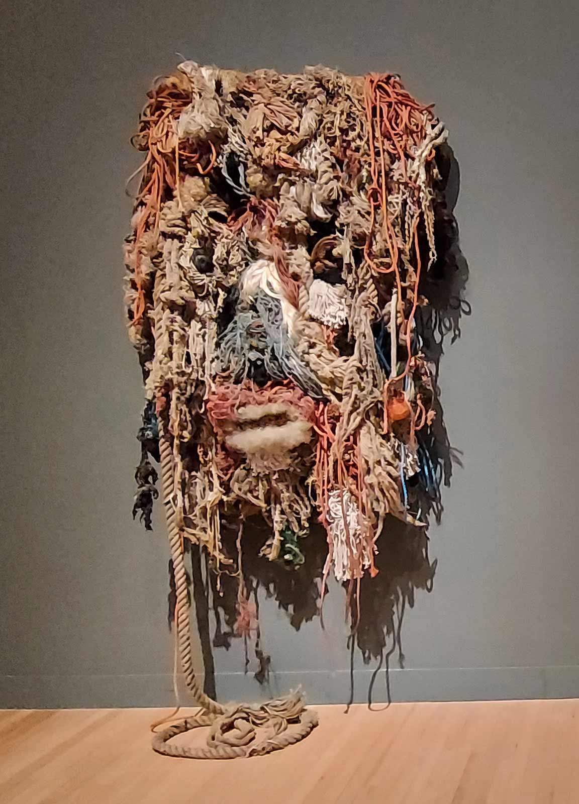 woven multi-coloured multi-weighted rope collage that looks like a bearded mythical face
