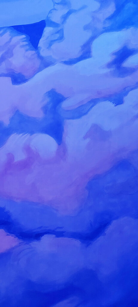 pale pink clouds with soft edges against a deep blue background